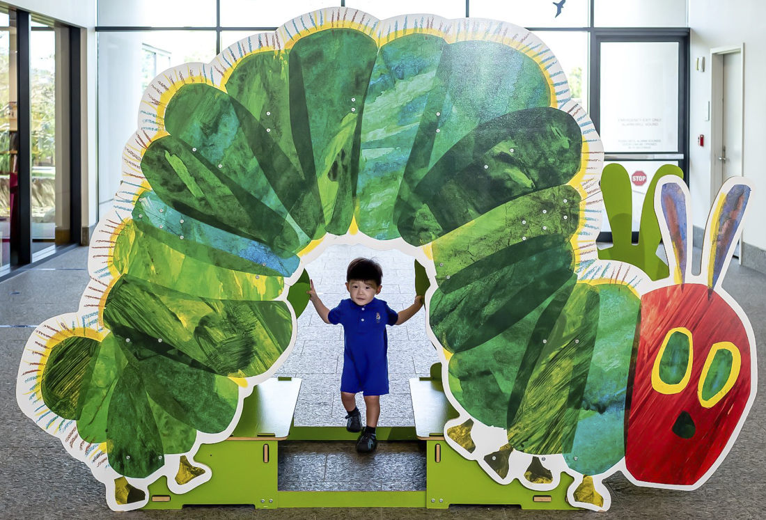 Image of child with the Very Hunger Caterpillar artwork.