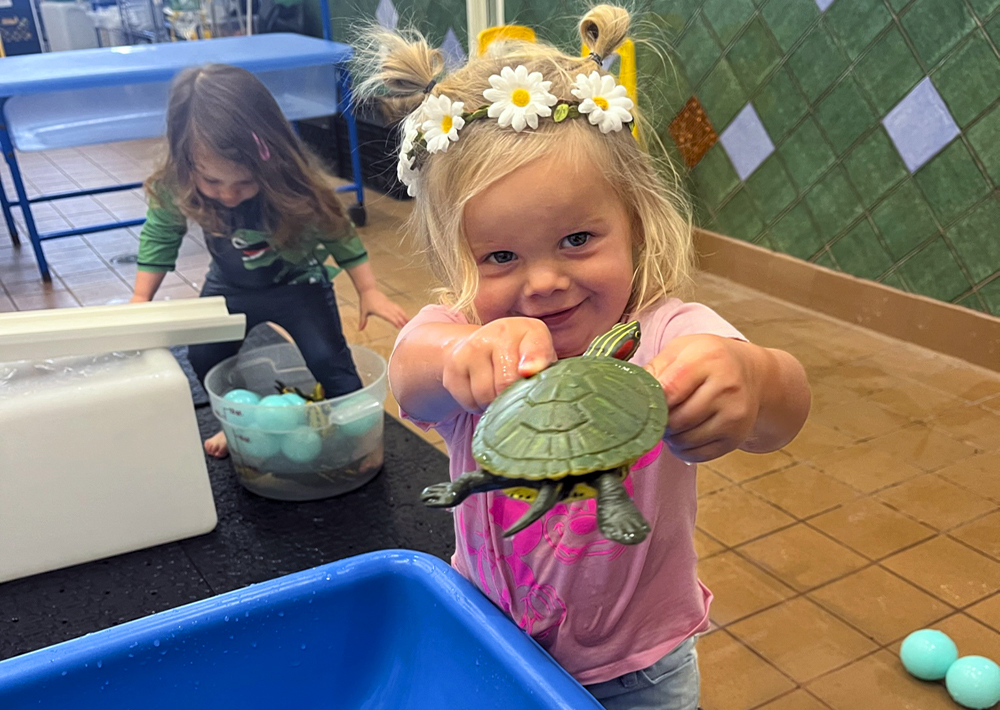 Not Your Average Playspace: Imaginology Kids Is Where Kids Learn While Playing Little girl playing in the water lab. Photo by Kylie Williams