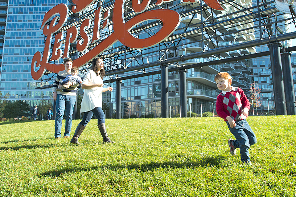 Play under the  iconic Pepsi Cola sign. Photo by Sidney Ng
